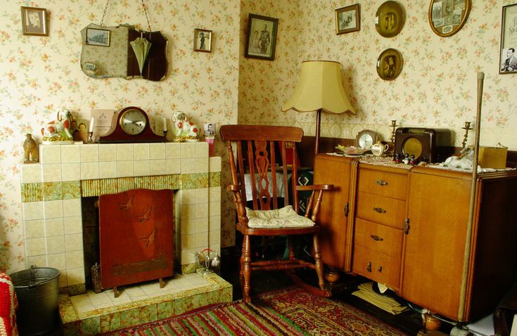 a living room filled with furniture and a fire place next to a wall mounted clock