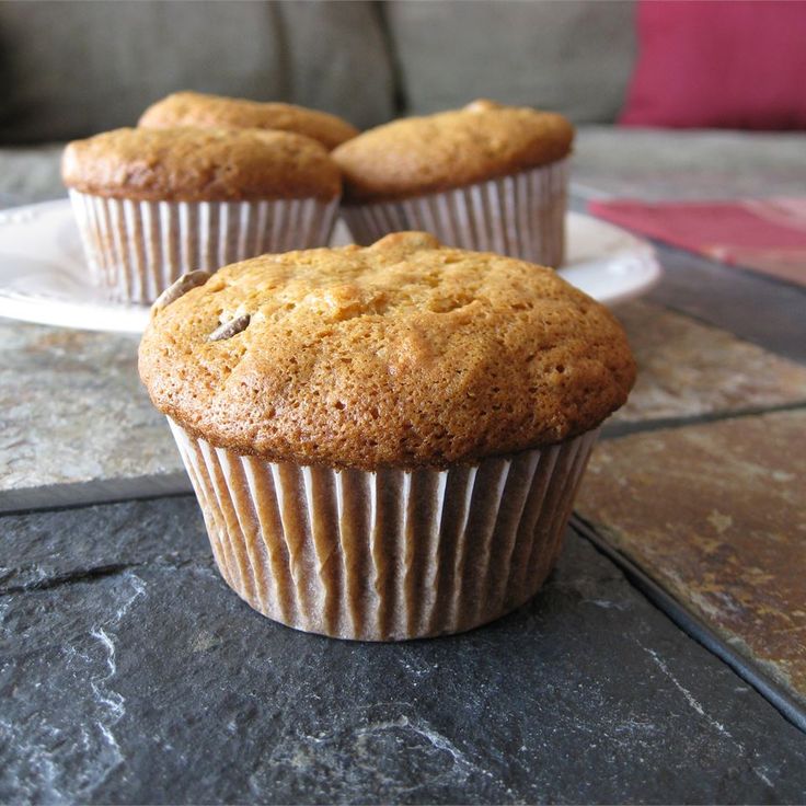 three muffins sitting on top of a white plate