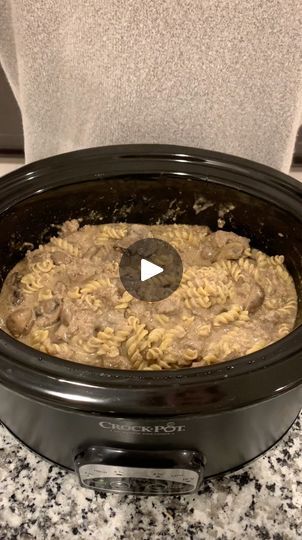 a crock pot filled with macaroni and cheese sitting on top of a counter