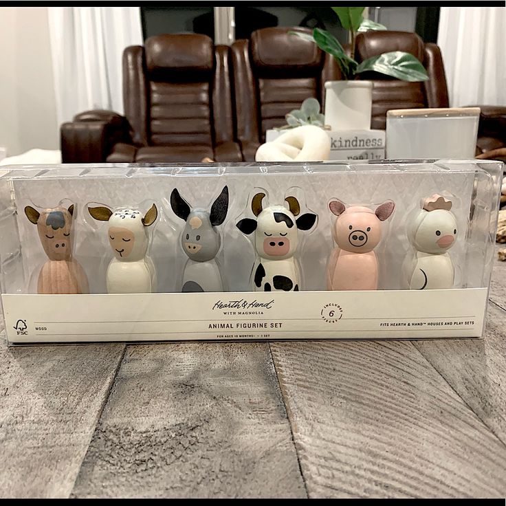 four little toy animals are in the box