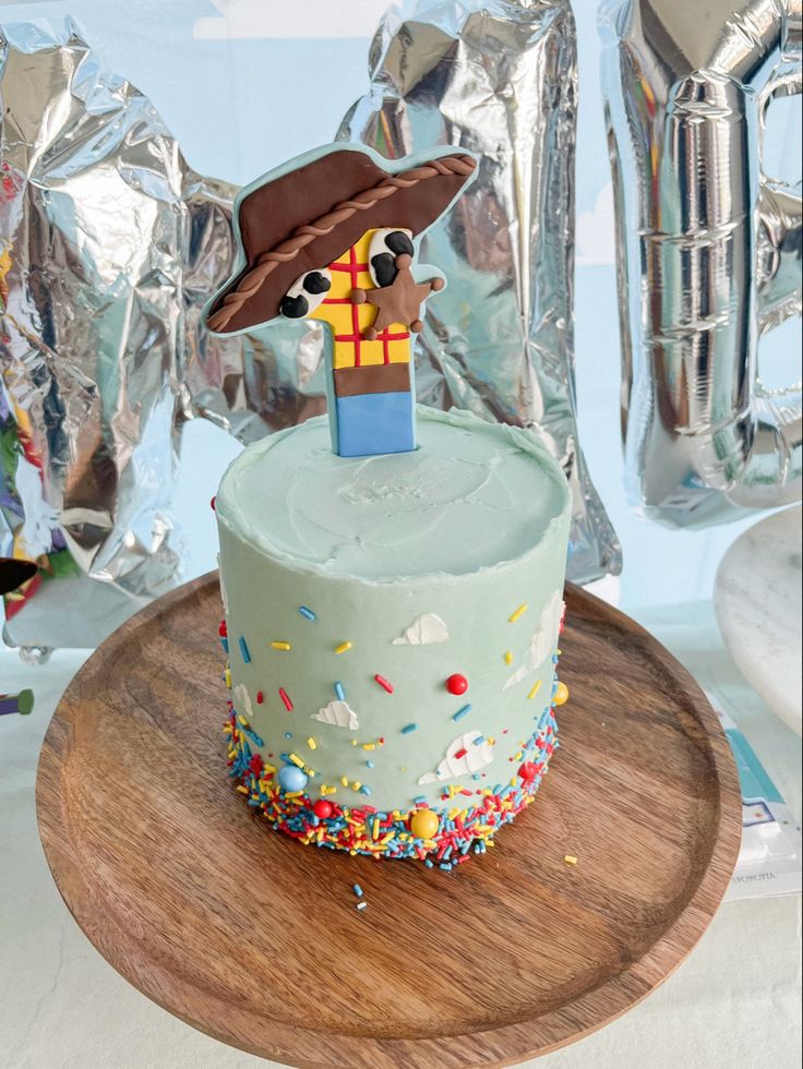 a birthday cake with sprinkles and a hat on top