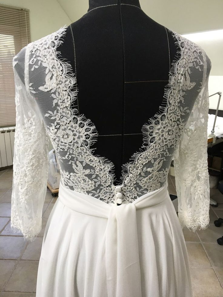 the back of a dress with white lace on it