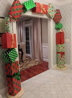 two christmas presents are stacked on top of each other in front of a mirror with the door open