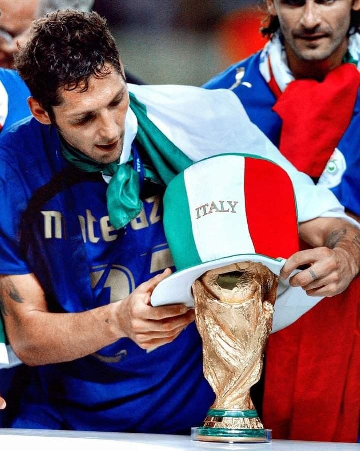 a soccer player is holding the world cup