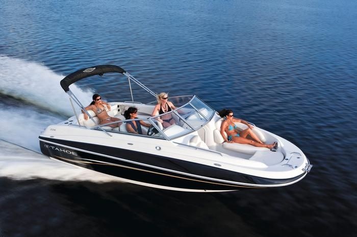 four people on a speed boat in the water