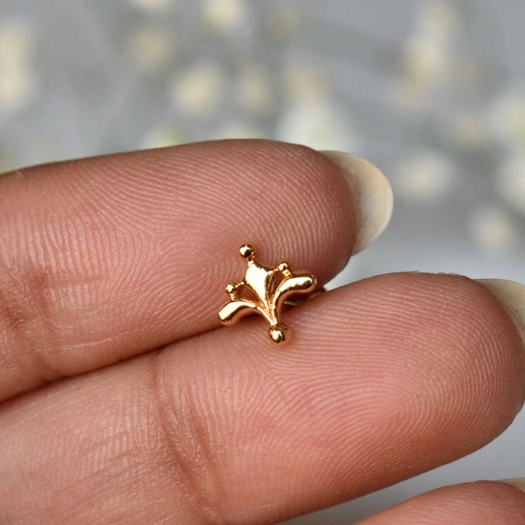 "Inspired from the beautiful Mughal motifs, this gold floral stud is a perfect piece for all your piercings. Crafted in 14k solid gold, this one of a kind pin makes for a great gift for a piercing lover and your loved ones. Great for your tragus, lobe, conch, helix, flat piercing. It also makes for a mesmerizing nose jewelry. * Dimension : 7x7mm (approx.) * Material : 14k Solid Gold If you like this stud, please press \"Pin it\" button on the top of your screen. Follow us on Instagram : @abhikaj Elegant Hypoallergenic Nose Rings For Gifts, Elegant Hypoallergenic 14k Gold Nose Rings, Elegant 14k Gold Nose Ring As Gift, Delicate 14k Yellow Gold Piercings, Gold Internally Threaded Elegant Nose Studs, Gold Dainty Tarnish-resistant Cartilage Earrings, Dainty Gold Cartilage Earrings Tarnish Resistant, Dainty Gold Tarnish-resistant Cartilage Earrings, Wedding Yellow Gold Internally Threaded Nose Rings