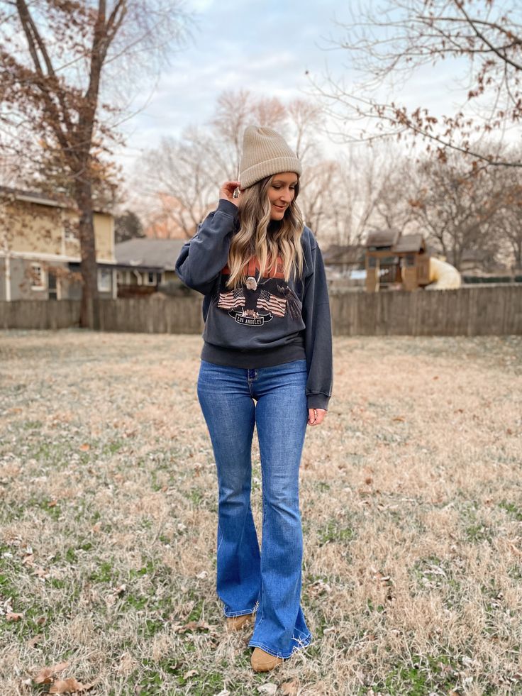 Anine Bing sweatshirt, Aerie beanie, Abercrobie flare jeans and Zara flats. Winter outfit idea. Cold Weather Outfits Bootcut Jeans, Casual Sweatshirt Outfit With Jeans, Flare Jeans With Sweater Outfit, Flare Jeans And Tshirt Outfit, Sweatshirt And Flare Jeans, Flare Jeans And Sweatshirt Outfit, Flare Jeans And Crewneck Outfit, American Eagle Flare Jeans Outfit, Bell Bottom Jeans Outfit Winter Casual