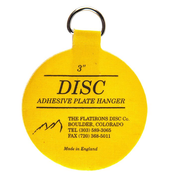 a yellow disc shaped keychain with an adhesive plate hanger attached to it