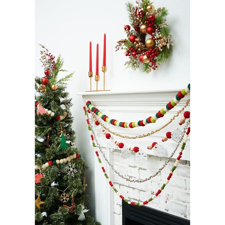 a decorated christmas tree next to a fireplace