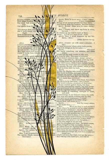 an old book page with some plants growing out of the top and bottom of it