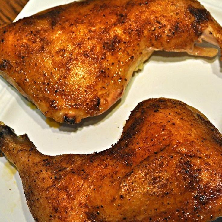 two pieces of chicken on a plate with the words rustic roasted chicken over it