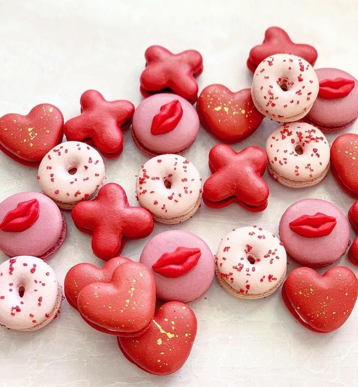 red and pink heart shaped donuts with sprinkles in the shape of hearts