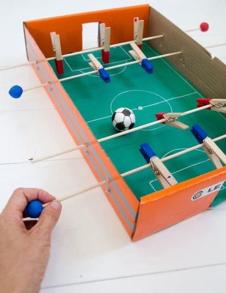 a person is playing with a foosball game on the table and it's blue balls