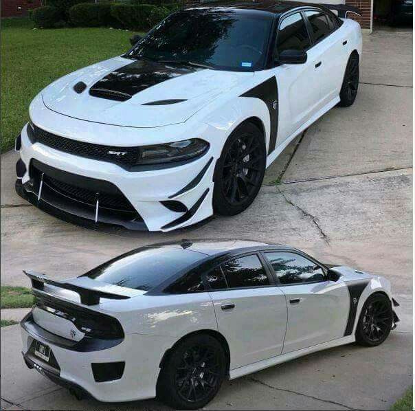 two white cars parked in front of each other on the side of a driveway next to a house