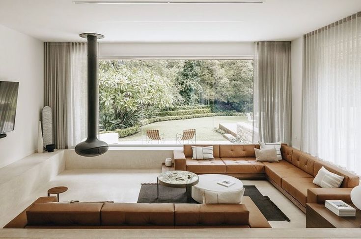 a living room filled with furniture and a flat screen tv mounted to the side of a wall