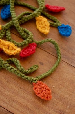 a crocheted piece of string on top of a wooden floor with colorful beads