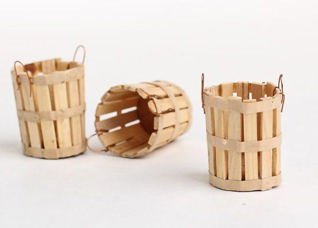 three bamboo baskets sitting next to each other on a white surface with no one in them