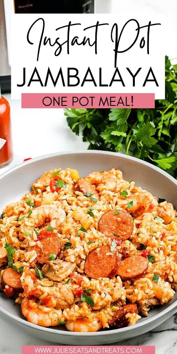 a bowl filled with rice and sausage on top of a table next to parsley