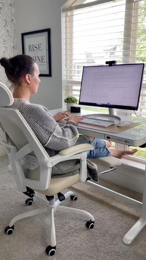 a woman sitting at a desk using a computer