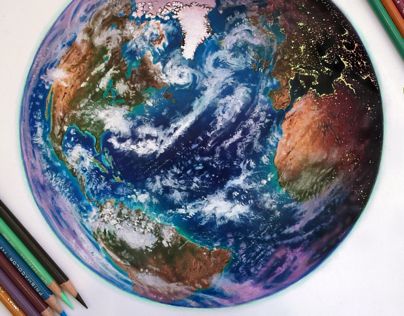 the earth is surrounded by colored pencils and crayons on a white surface