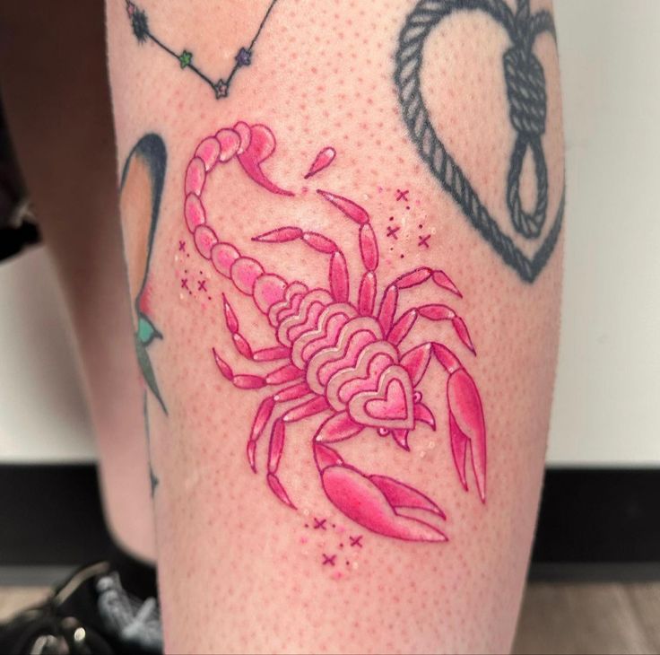 a close up of a person's leg with tattoos on it and a crab