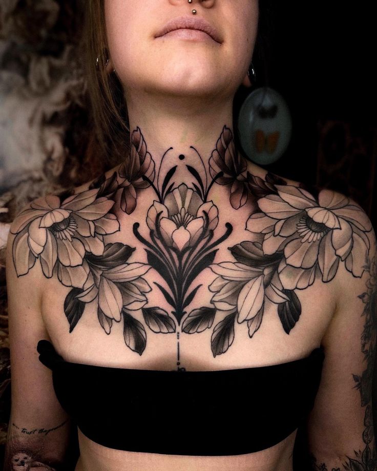 a woman with tattoos on her chest and neck