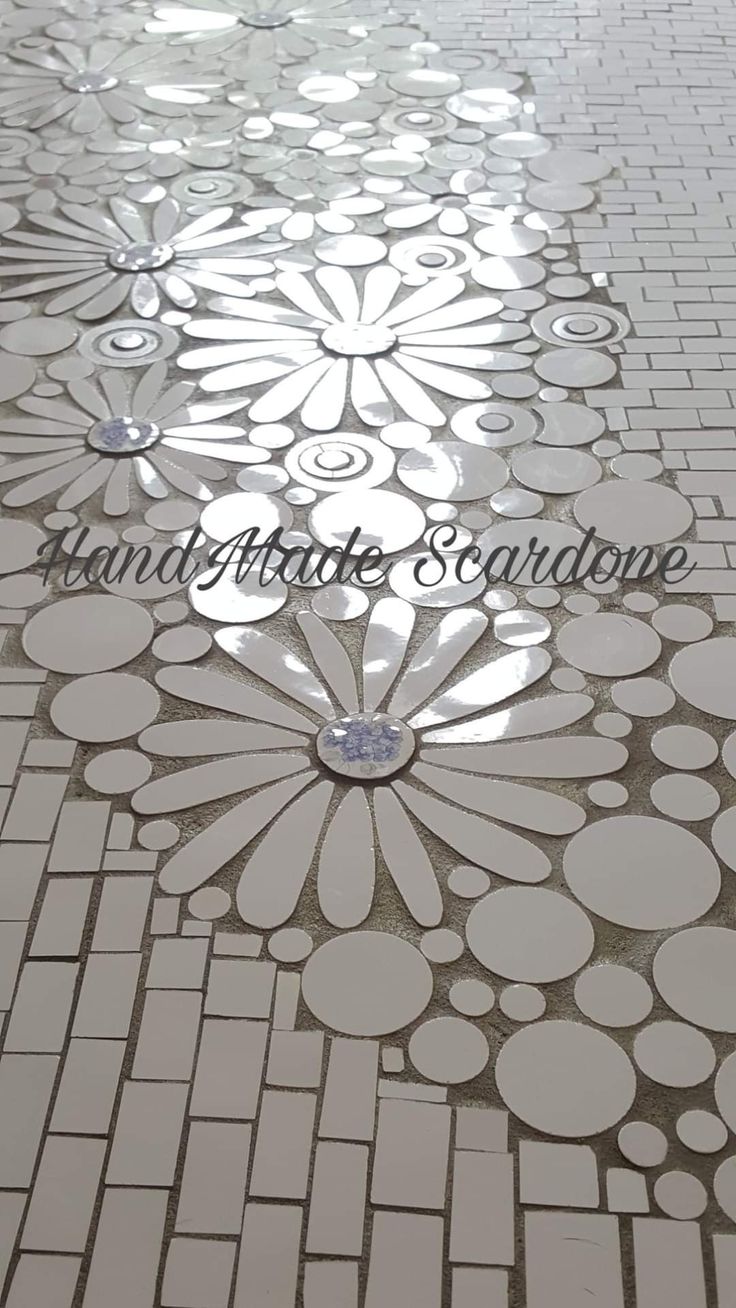 an artisticly designed tile floor is shown in white and grey colors with the words handmade creations on it