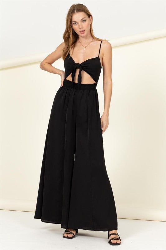 Elevate your party look or update your vacation clothes! Lightweight fabric makes up this sexy jumpsuit that has a bow tied front, connecting the two sides and leaving a sexy cut out detail. A high waist transitions into wide pant legs for a look that you'll love.Model is wearing a small, Height: 5'9", Bust: 34C, Waist: 24", Hips: 35" 100% Polyester, Stretch fabric, Non-sheer fabricCare Instructions: Machine wash cold, gentle cycle, tumble dry low. Cutout Jumpsuit, Jumpsuit Fitted, Remember Me, Boho Print, Yacht Club, Wide Pants, Wide Leg Jumpsuit, Black Jumpsuit, Sheer Fabrics