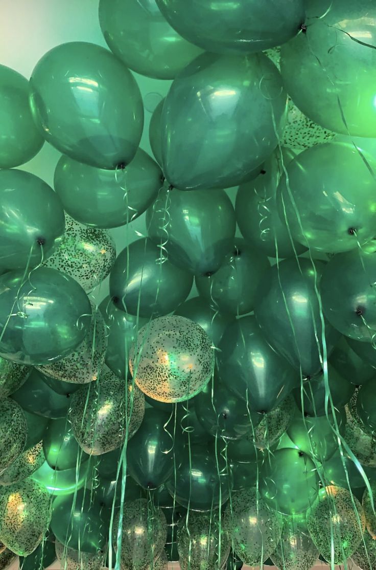 green balloons are floating in the air