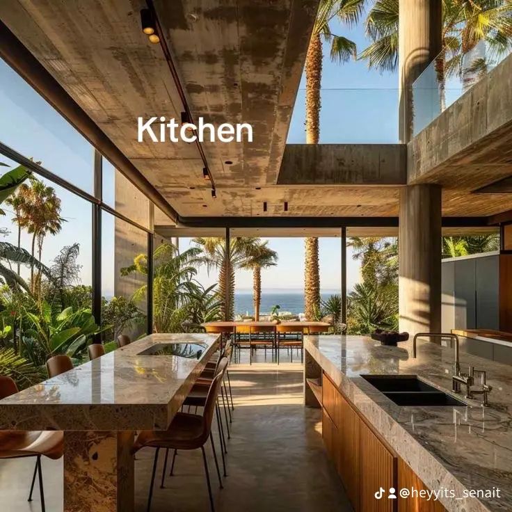 an open kitchen and dining area with palm trees