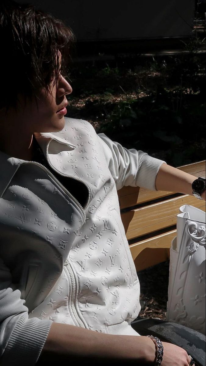 a person sitting on a bench with a handbag