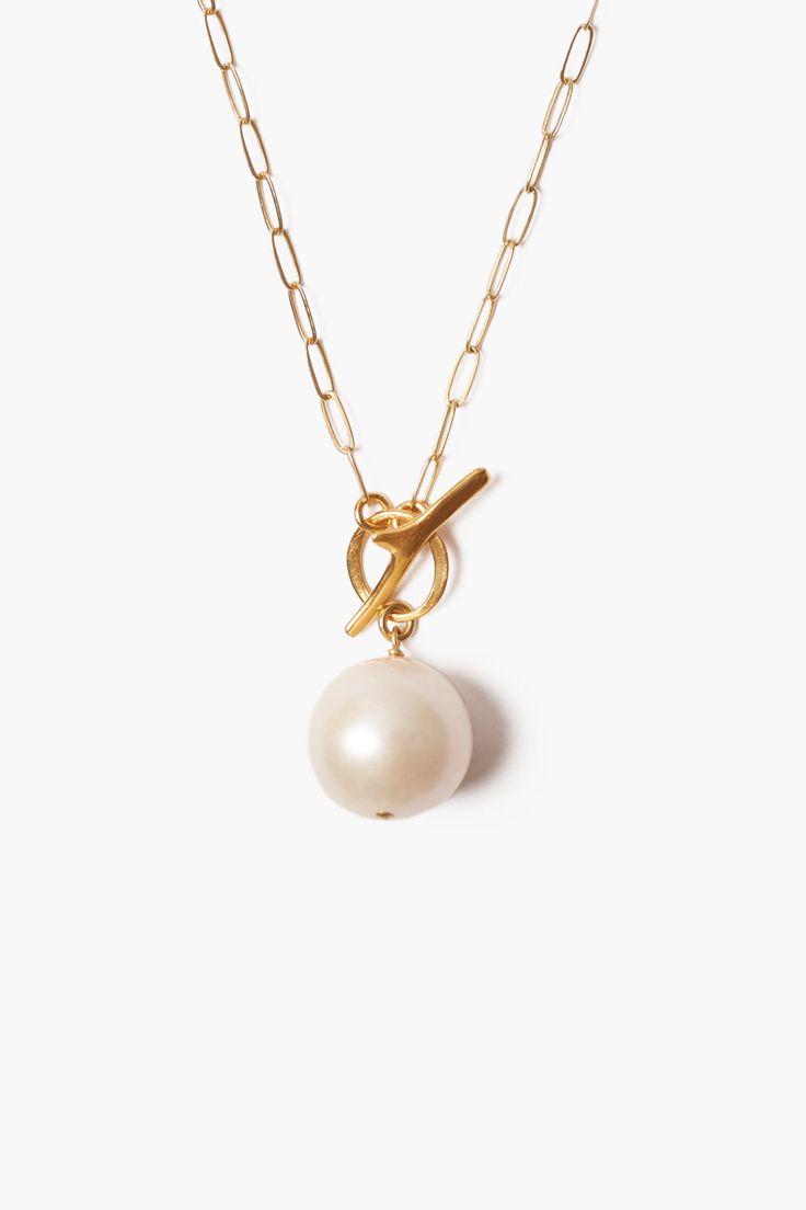 Short 18k gold plated necklace featuring a White freshwater pearl. Fastens with a toggle and ring closure. 18k gold plated sterling silver, White freshwater pearl Necklace: 17", Pendant Drop Approx: 0.73" Handmade in Vietnam Gold Toggle Necklace With Pearl Charm, White Pearl Toggle Necklace With Pearl Pendant, Gold Pearl Elegant Toggle Necklace, Gold Pearl Toggle Necklace, Classic Gold Pearl Necklace With Toggle Clasp, Closet Inventory, Keshi Pearl Earrings, Toggle Necklace, Gold Charms