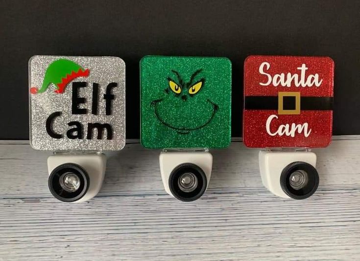 three christmas decorations on top of each other with the words elf cam and santa can