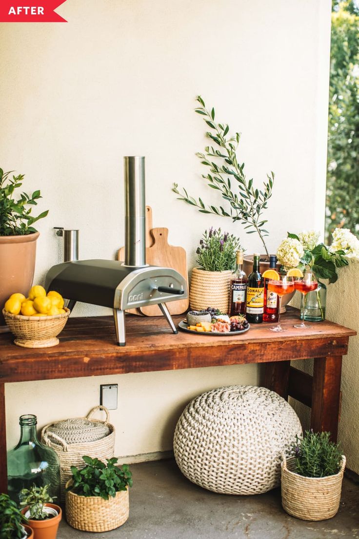 an outdoor kitchen with potted plants, lemons and other items on the counter