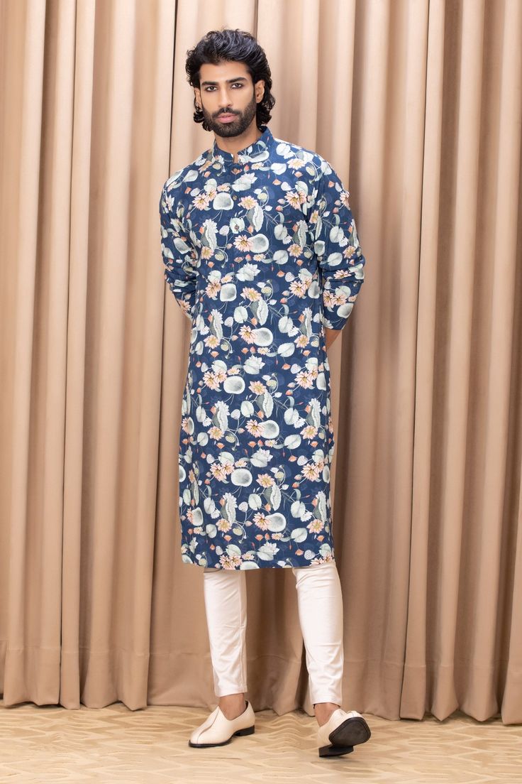 Navy blue kurta with digital printed hand painted floral motifs. Comes with an ivory churidar.
Component: 2
Pattern: Digital Print
Type Of Work: Floral Patterns
Neckline: Mandarin Collar
Sleeve Type: Straight Long
Fabric: Cotton and Silk
Color: Blue
Other Details: 
Front button placket
Note: Pant worn by the model is not for sale
Occasion: Sangeet - Aza Fashions Blue Kurta, Kurta Set For Men, Lotus Print, Churidar, Kurta Set, Floral Motifs, Floral Patterns, Mandarin Collar, Aza Fashion