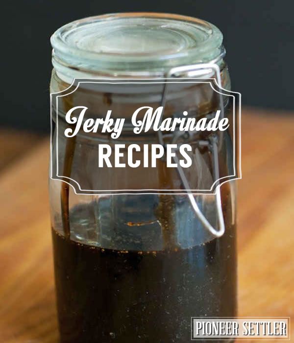 a jar filled with black liquid sitting on top of a wooden table