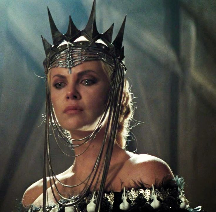 a woman wearing a crown and chain around her neck