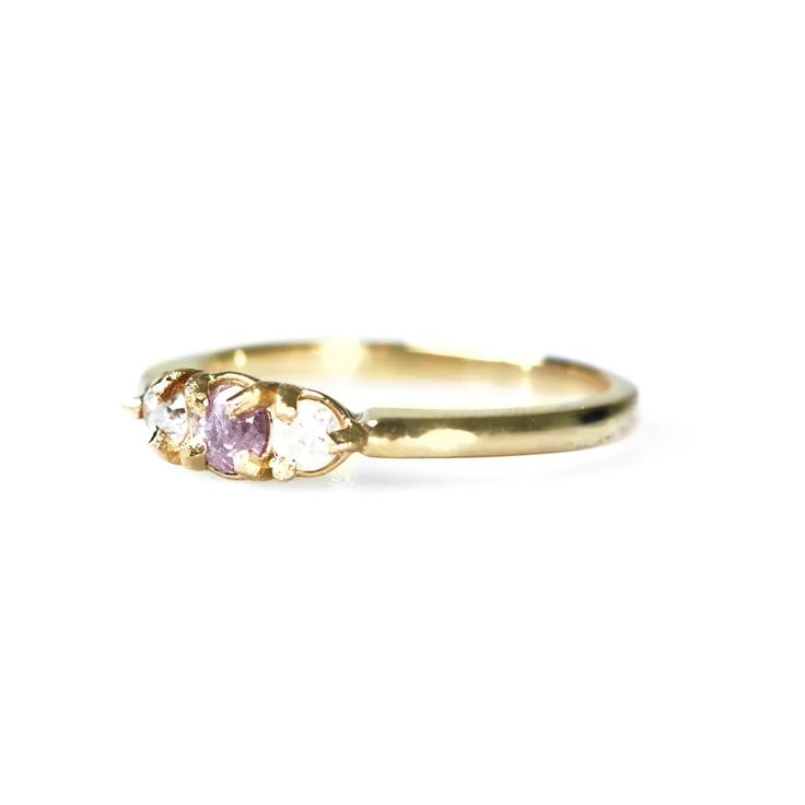 a yellow gold ring with two pink stones on the front and one white stone in the back