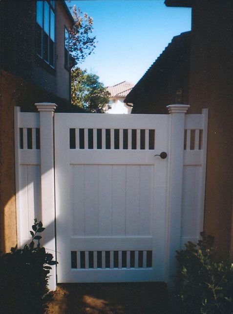 a white gate in front of a house