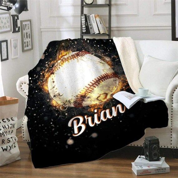 a baseball blanket with the name braun on it in front of a white couch and bookshelf