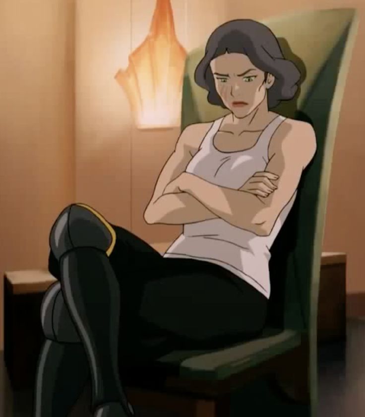 a woman sitting in a chair with her arms crossed