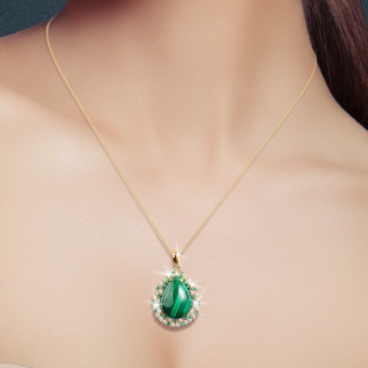 Malachite is a gorgeous green gemstone. Its light and dark green bands are very distinctive. It is said that Malachite can be worn to detect impending danger and it is believed to lend extra energy and bring harmony into one’s life. Crafted from sterling silver, plated in rich yellow gold suspends a teardrop of Malachite surrounded in shimmering white Diamondeau®, flawless simulated diamond. Luxury Malachite Elegant Necklace, Luxury Gold Malachite Necklace, Malachite Gemstone Round Pendant Necklace, Luxury Malachite Pendant Jewelry, Spiritual Malachite Pendant Necklace, Malachite Pendant, Green Gemstones, Dark Green, Time Piece