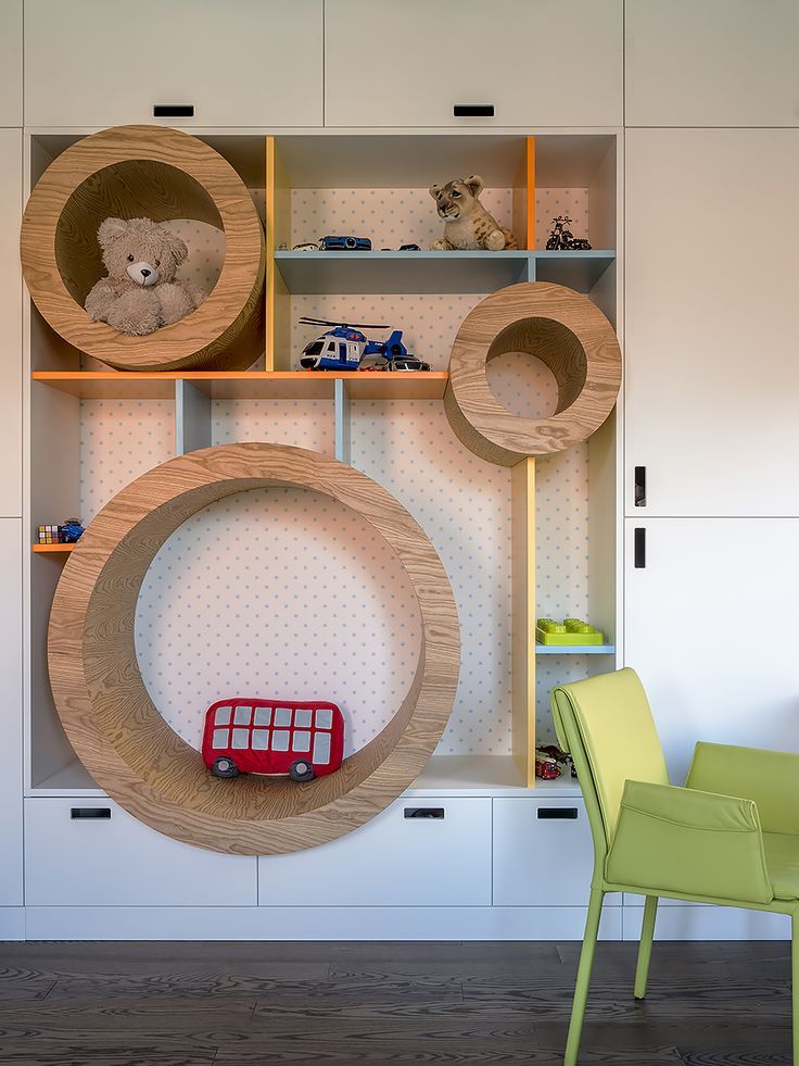 there is a toy car in front of the bookshelf with shelves on both sides