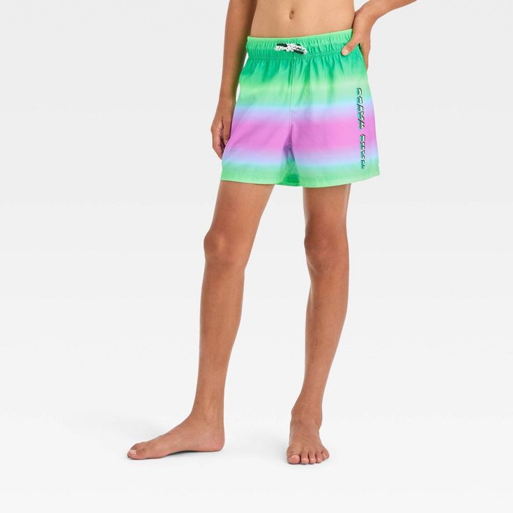 They'll be ready for outdoor fun in these Ombre Design Swim Shorts from art class™. These mid-rise swim shorts are made from 100% recycled polyester with a built-in boxer for comfortable wear, while the UPF 50+ rated material offers them protection from the sun. Designed with two side pockets and a back flap pocket for functional style, they feature a full elastic waistband with a drawstring to help them find a secure fit. Showcasing an ombre print in green, pink and blue hues, they make a fun p Summer Green Shorts For Water Sports, Playful Sports Bottoms For Beach Season, Green Shorts For Water Sports In Summer, Green Swim Trunks For Water Sports, Green Athletic Shorts For Swimming In Summer, Playful Short Swim Trunks For Swimming, Sporty Bottoms For Summer Activities, Playful Short Swim Trunks For Summer Activities, Playful Swim Trunks For Summer Activities