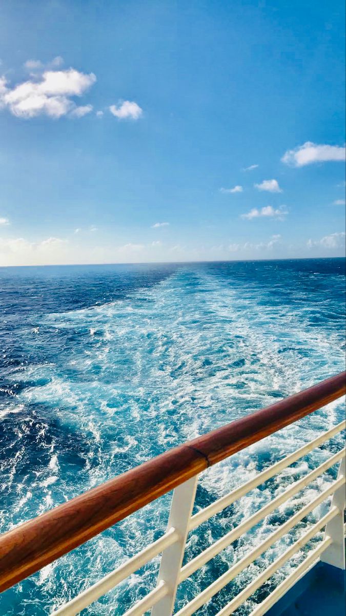 the back end of a cruise ship as it travels through the ocean on a sunny day