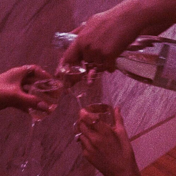 several people are holding wine glasses in their hands and toasting them with one another