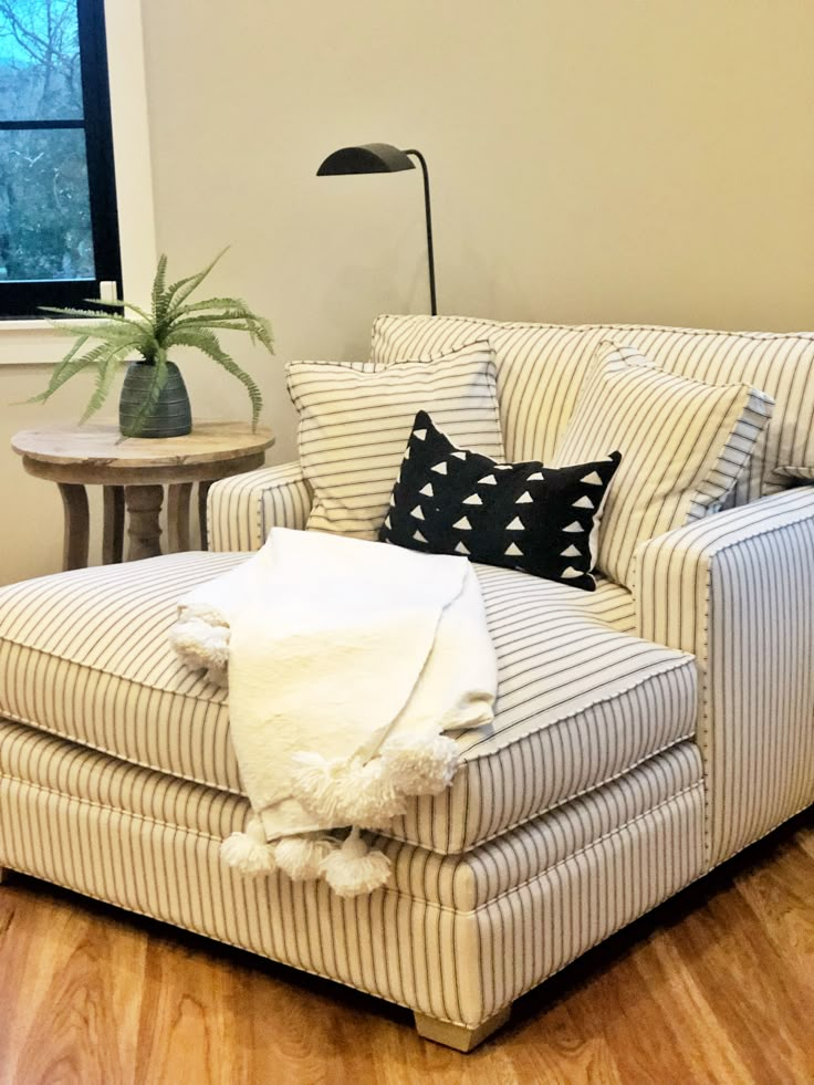 a chair and ottoman in a room with wood floors