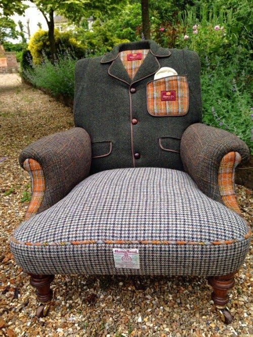 an upholstered chair sitting on top of gravel