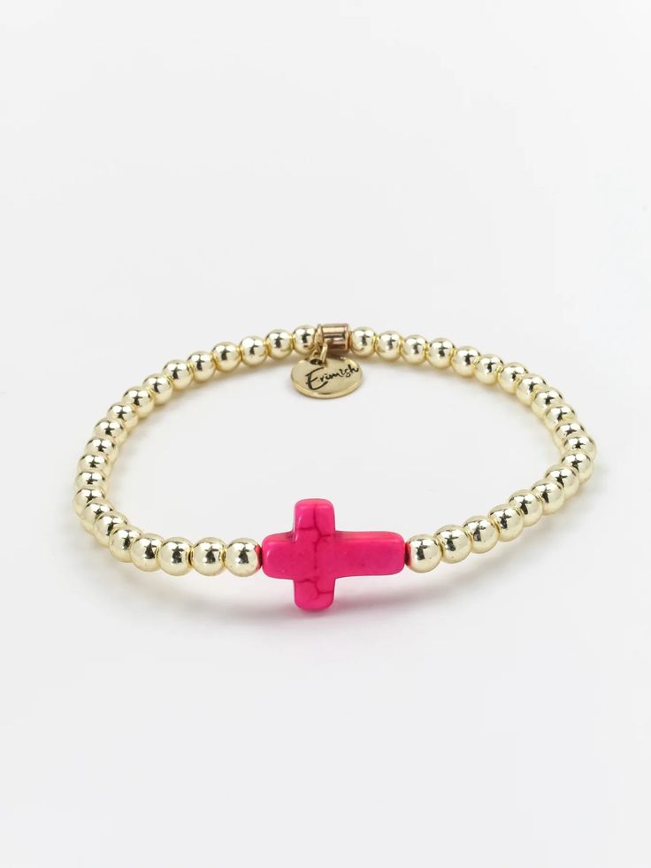 ERIMISH - CROSS SINGLE GOLD/PINK STACK BRACELET INFO Beautifully dainty, the cross bracelet brings all the charm. The classic design made with gold plated beads and a pink cross is perfect for everyday wear and will no doubt become a timeless piece in your collection. Bracelets are 'one size fits most' and are designed to fit wrists up to 7.5" comfortably. Synthetic Stretch Lead & Nickel Free Please be aware that due to the unique and handmade nature of each product, colors, shapes, and bead sizes may vary slightly from the photos and descriptions.