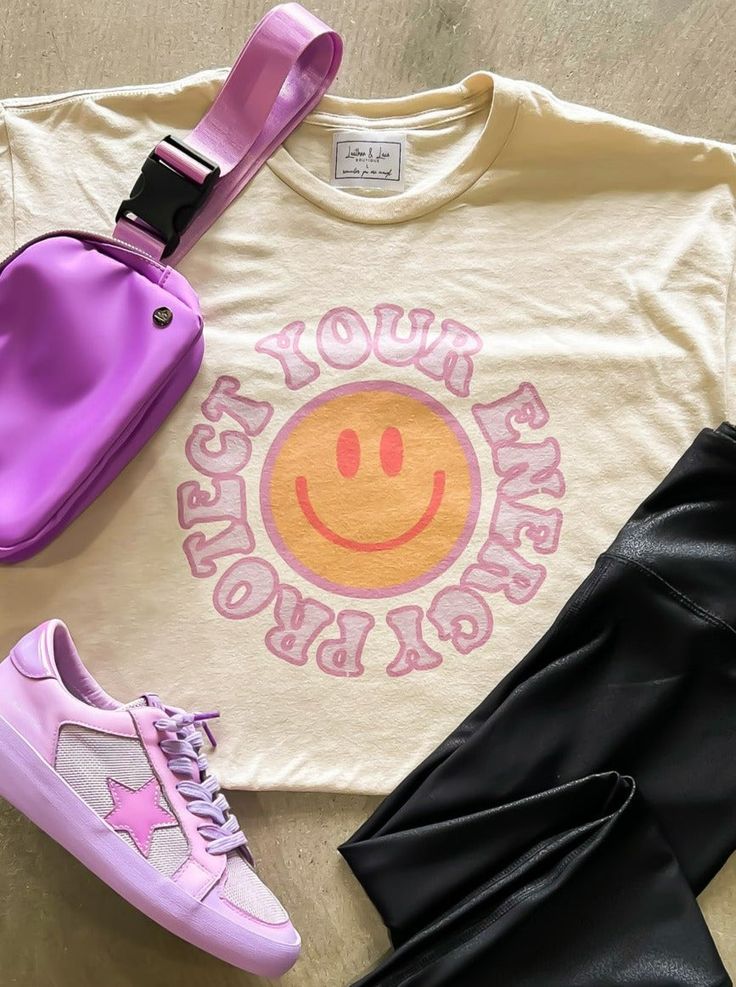 The "Protect Your Energy" graphic tee is the perfect addition to your spring wardrobe. With its retro design and edgy feel, this shirt is sure to make a statement. The colorful graphic adds a pop of fun to any outfit, making it a versatile piece for any occasion. Ships in 7-10 business days. Pink Graphic Tee With Graphic Print, Pink Smiley Face Graphic Tee, Stevie Nicks Songs, Cotton Smiley Face Graphic Tee, Groovy Graphic Print T-shirt For Streetwear, Groovy Relaxed Fit Graphic Print T-shirt, Boho Elements, Self Tanner, Stevie Nicks